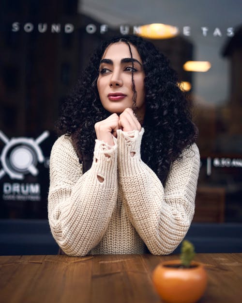 Woman Sitting in Sweater