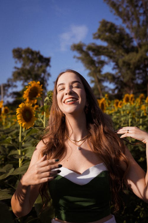 Portrait of Smiling Woman on Field of Sunflowers