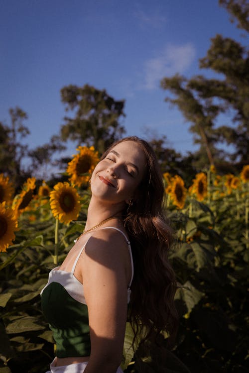 Beautiful Woman Posing with Sunflowers