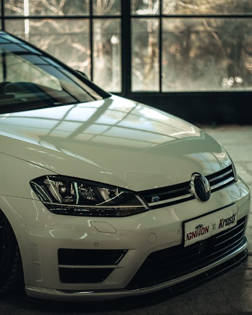 A White Volkswagen Golf VII Standing in a Showroom 
