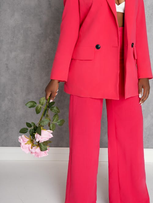 Close up of Woman in Red Suit Standing with Flowers