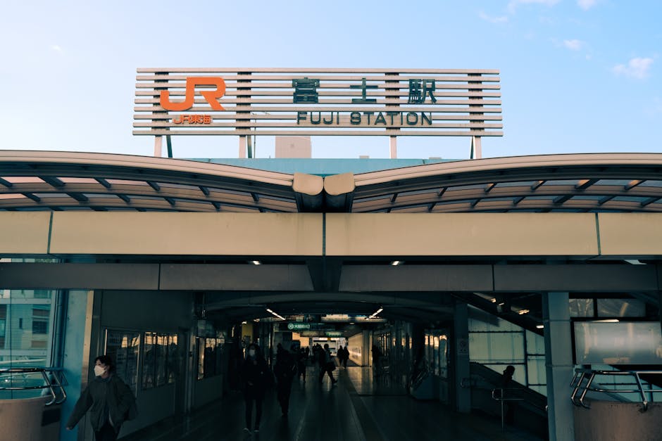 A bustling entrance to Fuji Station in Shizuoka, Japan, capturing urban transit life.