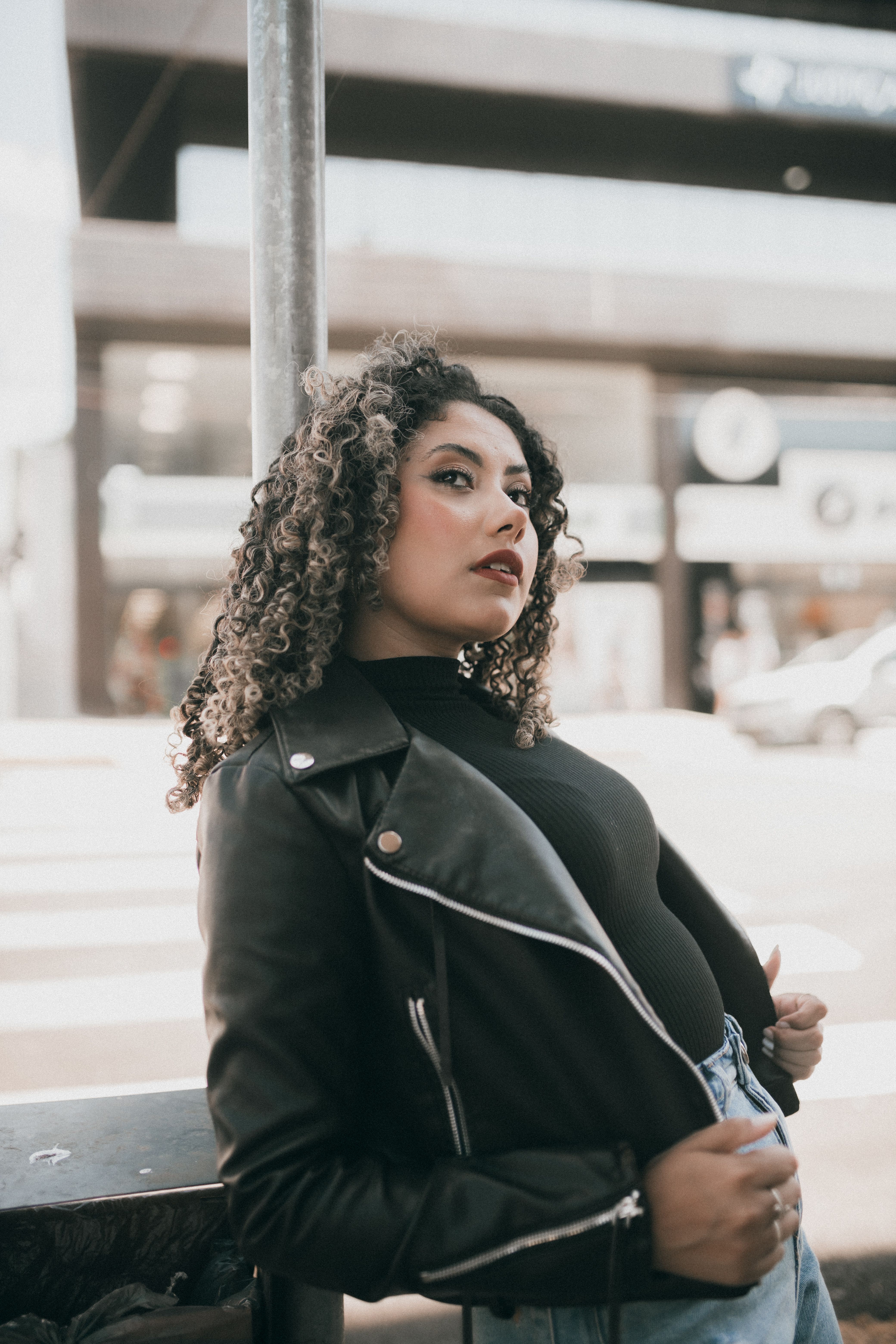Young Woman in a Leather Jacket Posing in City · Free Stock Photo