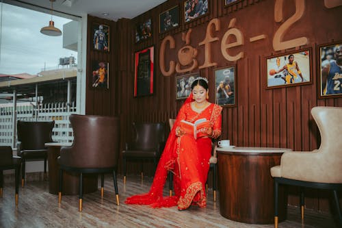 Woman in Traditional Clothing Sitting in Cafe