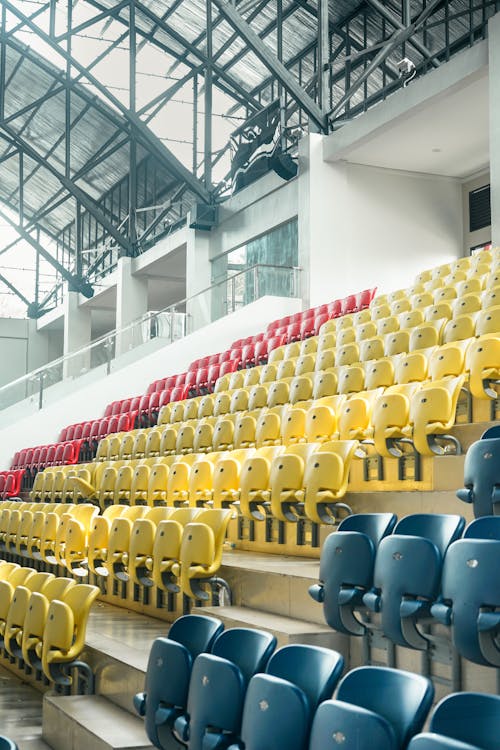 Rows of Multi Colored Plastic Seats at a Stadium 