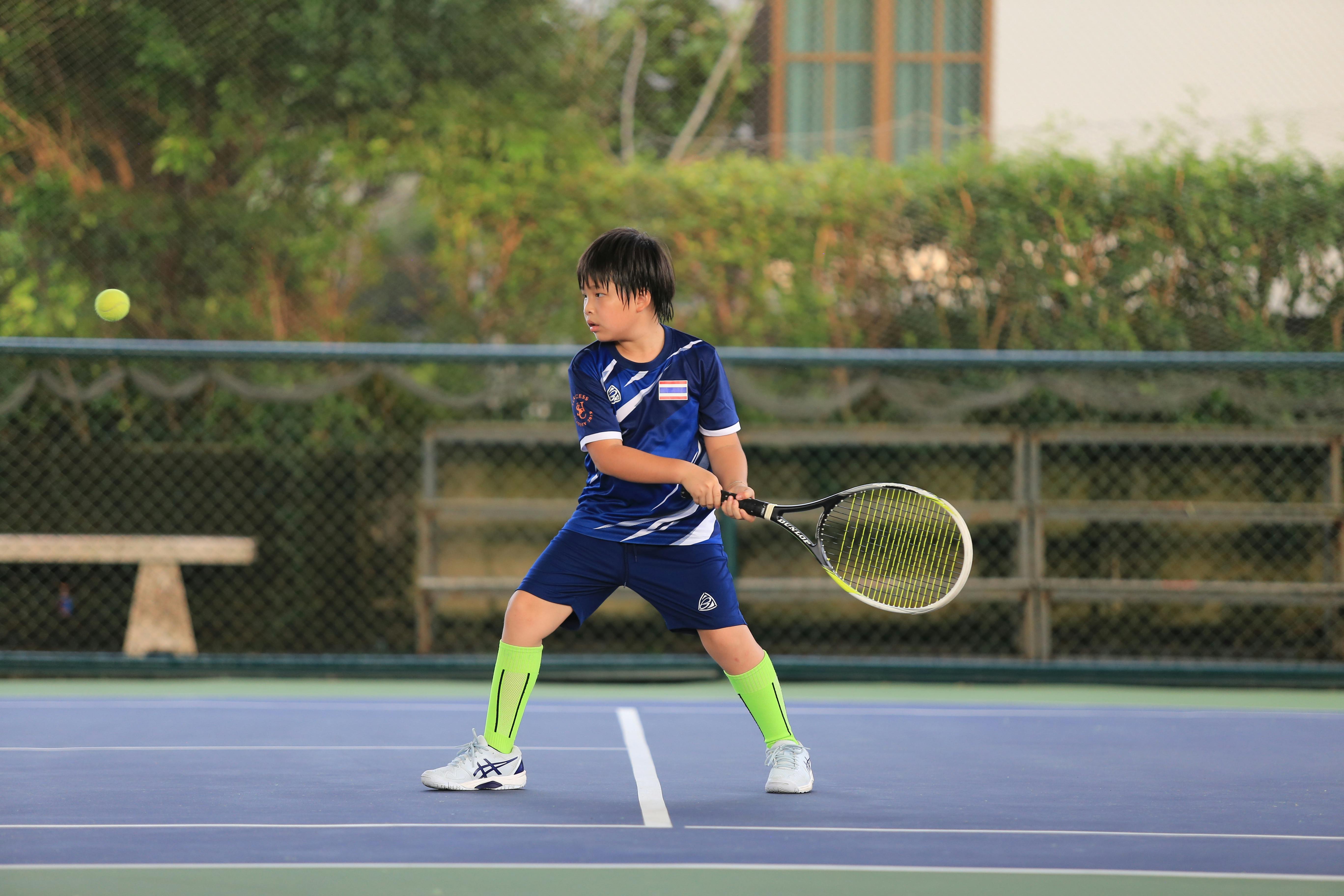 Young tennis player practicing form
