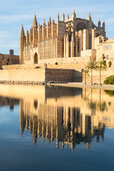 Stunning view of the Gothic Cathedral reflecting in water in Palma de Mallorca, Spain.