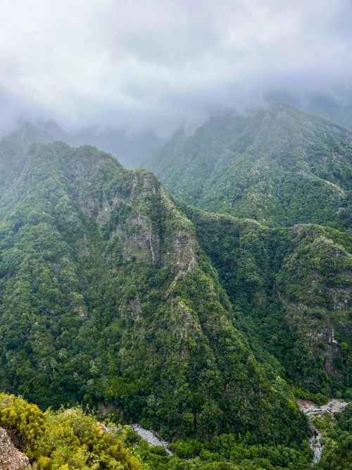 Free Stunning aerial view of verdant mountains in Madeira, Portugal, under misty clouds. Stock Photo