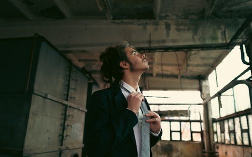 Man in Suit Fixing Necktie