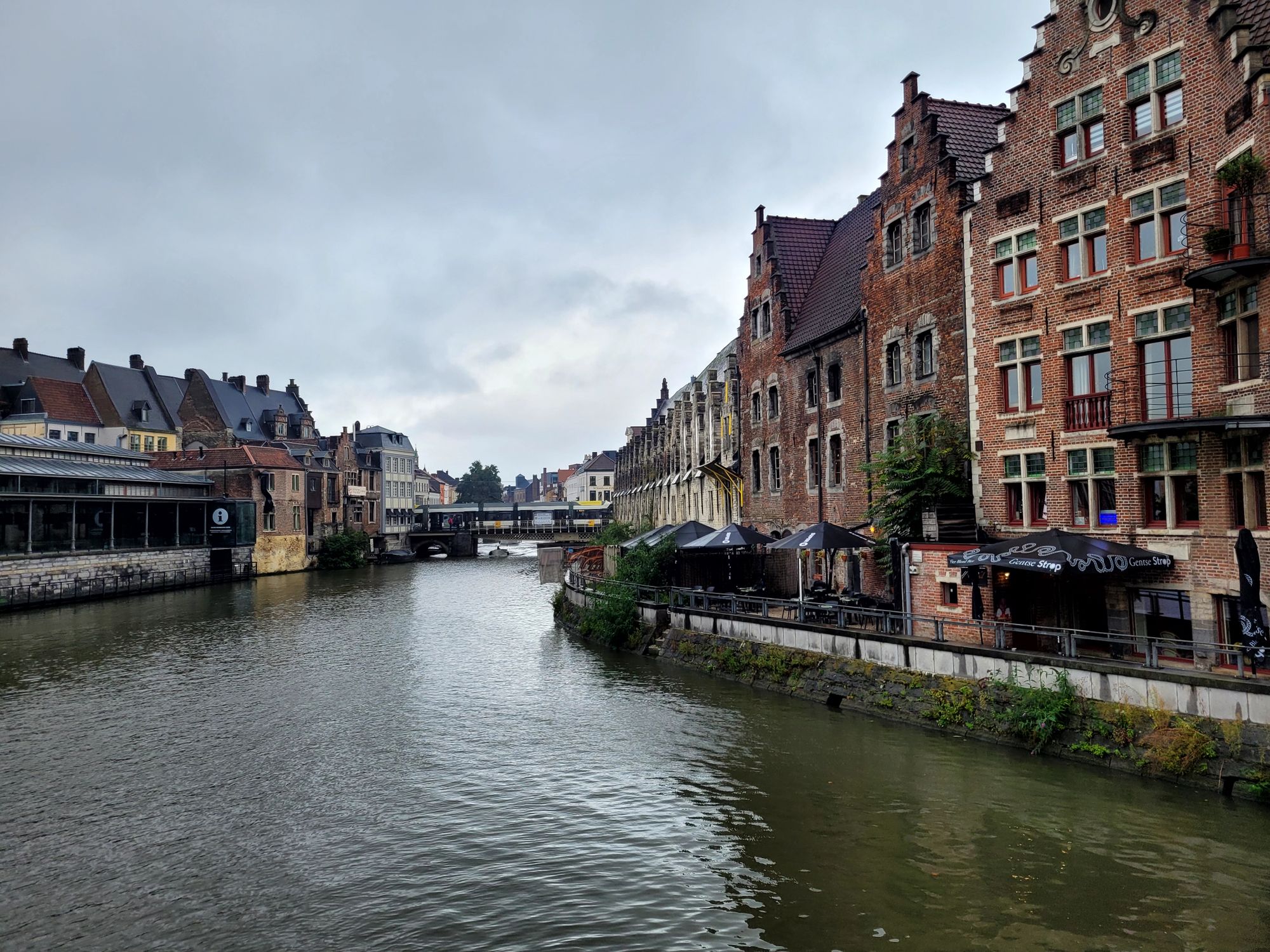 Charming view of historic canal and traditional buildings in Ghent, Belgium. Ideal travel shot.