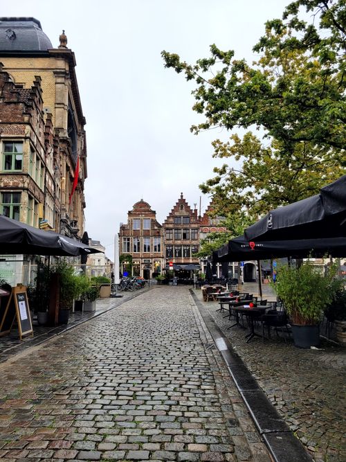 Free Explore the picturesque cobblestone streets of Ghent, featuring historic architecture and outdoor cafes. Stock Photo