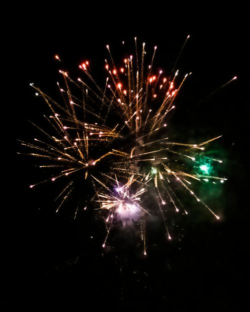Free A vibrant fireworks display illuminates the night sky with colorful bursts and sparkling trails. Stock Photo