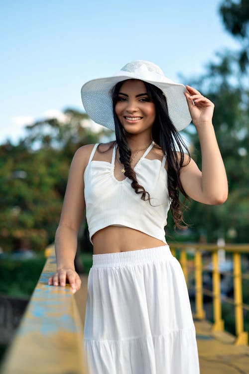 Brunette Woman in White Top and Skirt