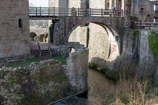 A bridge over a river with a castle in the background