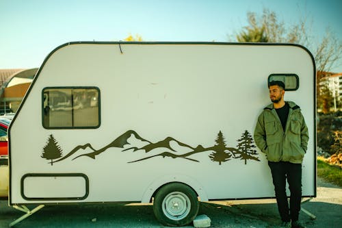 A Man Standing by a Trailer