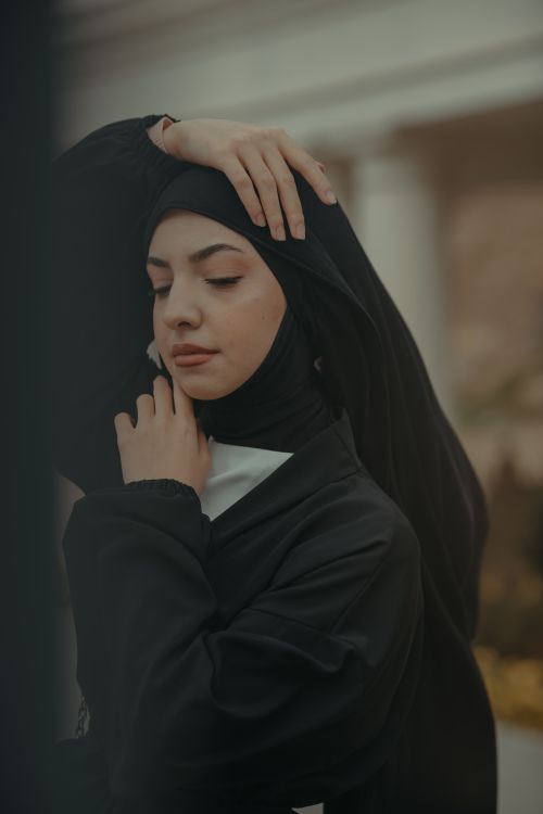 Free Beautiful portrait of a woman in a hijab with eyes closed, in serene and graceful pose. Stock Photo