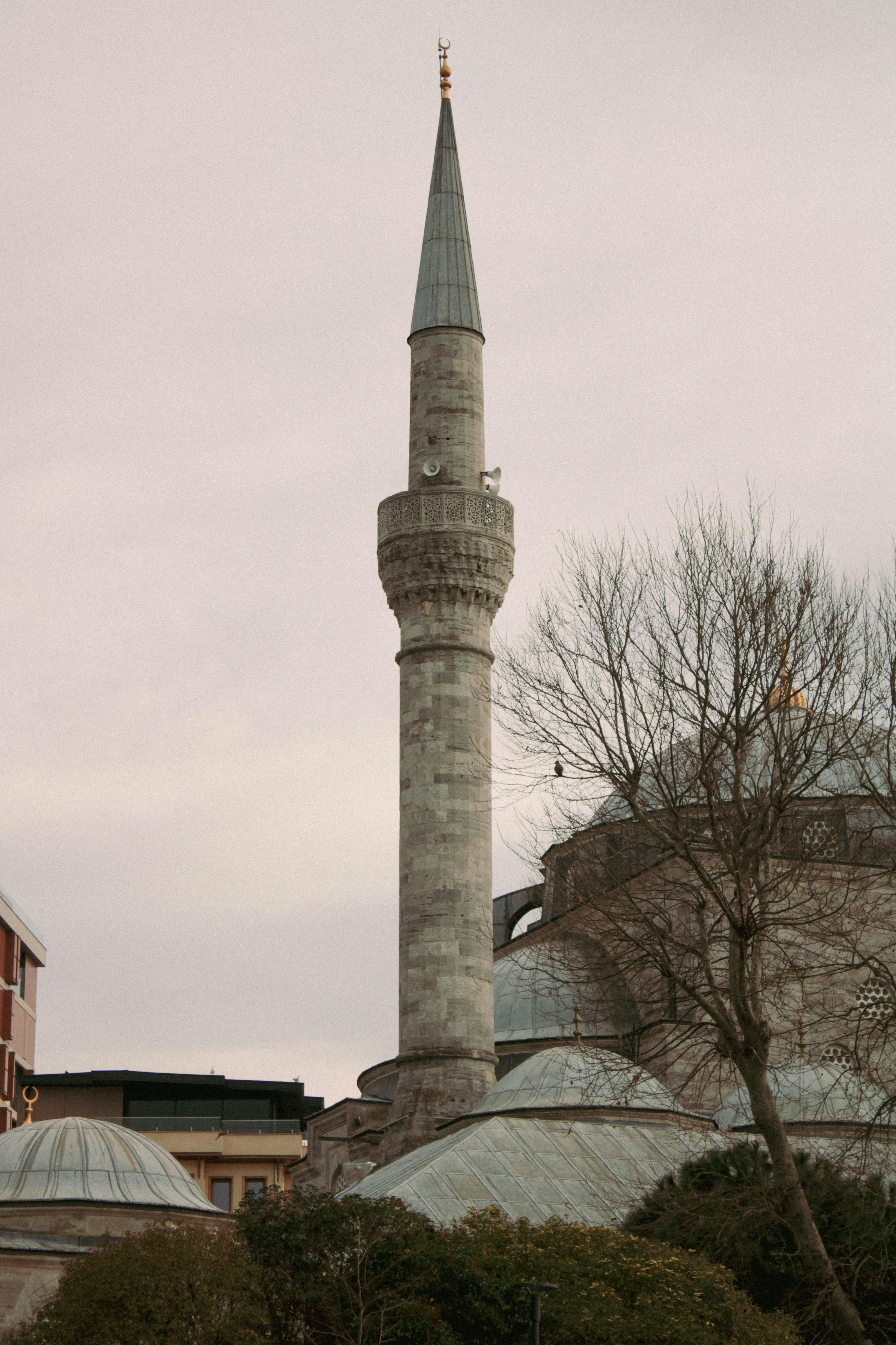 Elevated view of a historic minaret showcasing Ottoman architectural elegance in Istanbul.