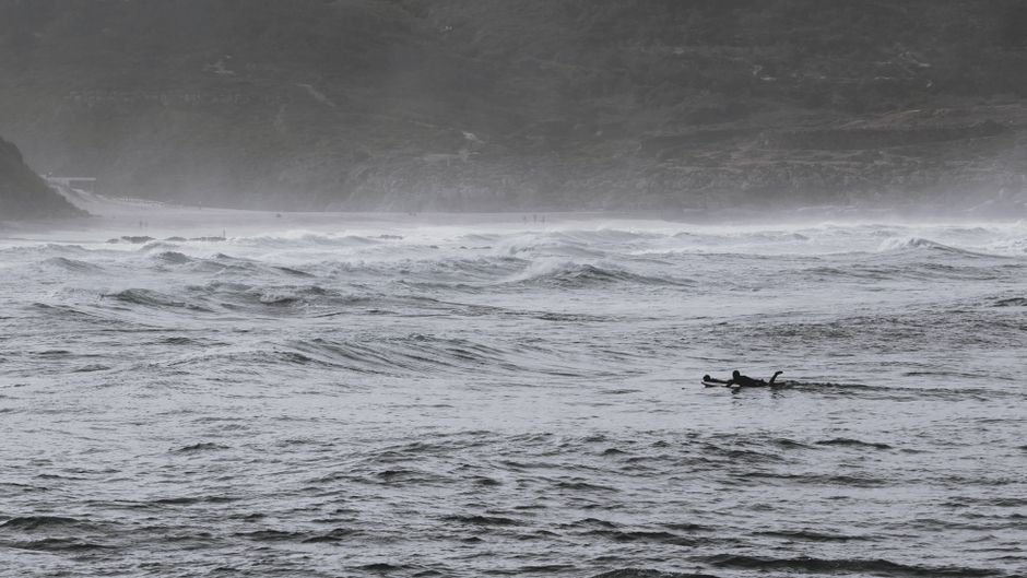 Surfers ride the dynamic waves of Ericeira Beach in Portugal, showcasing adventure in nature.