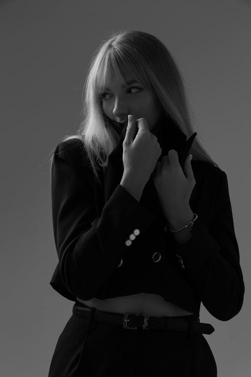 Free Black and White Studio Shot of a Young Woman in Fashionable Outfit  Stock Photo