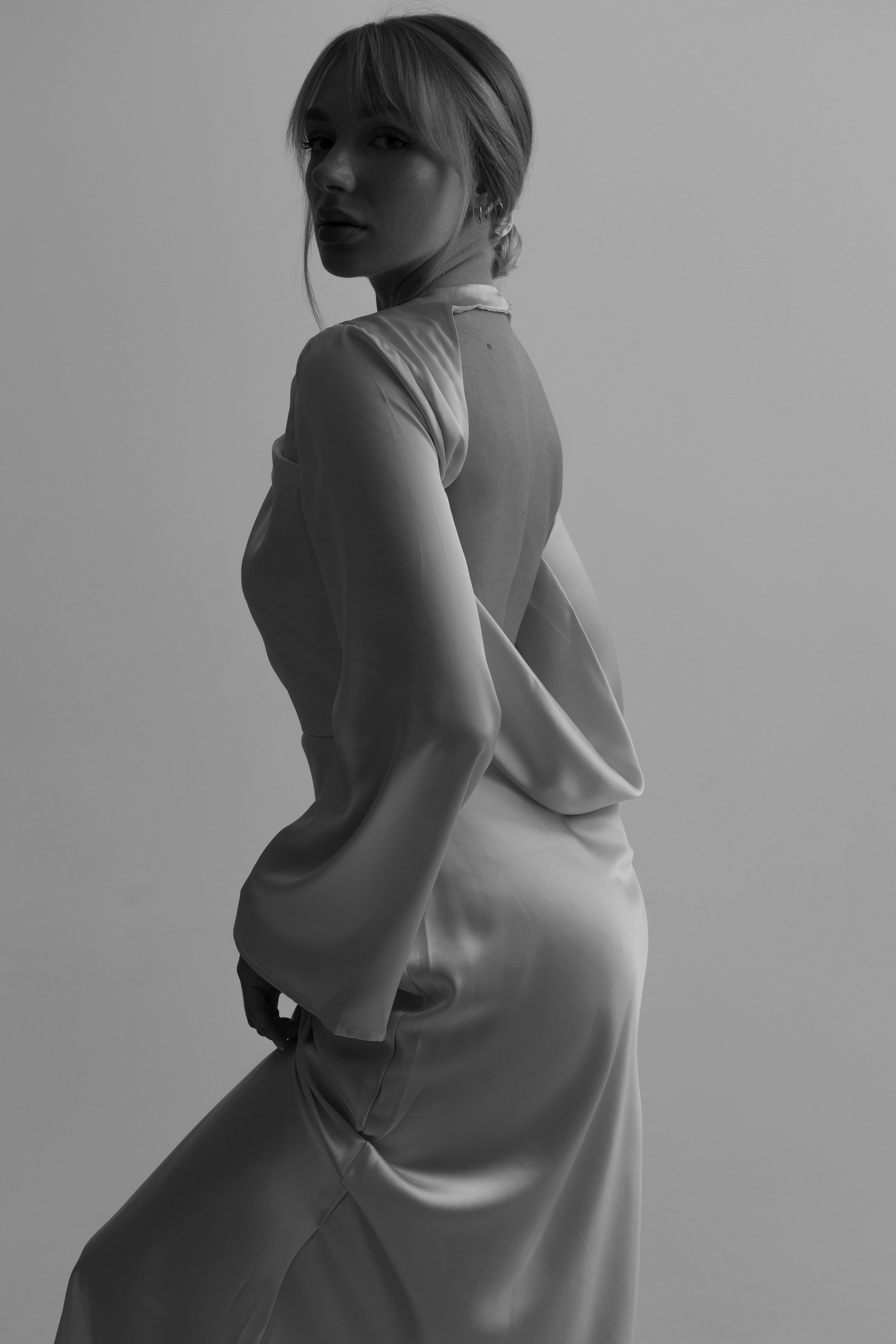 Free Black and white side profile of a woman in an elegant, backless evening dress. Stock Photo