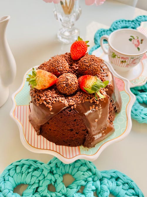 A Chocolate Cake with Chocolate Icing and Strawberries on Top 