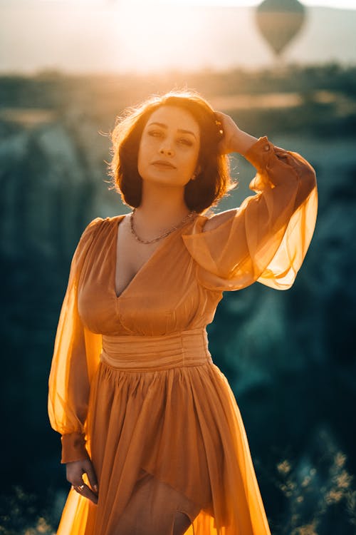 Woman in a Dress Posing Outside at Sunset 