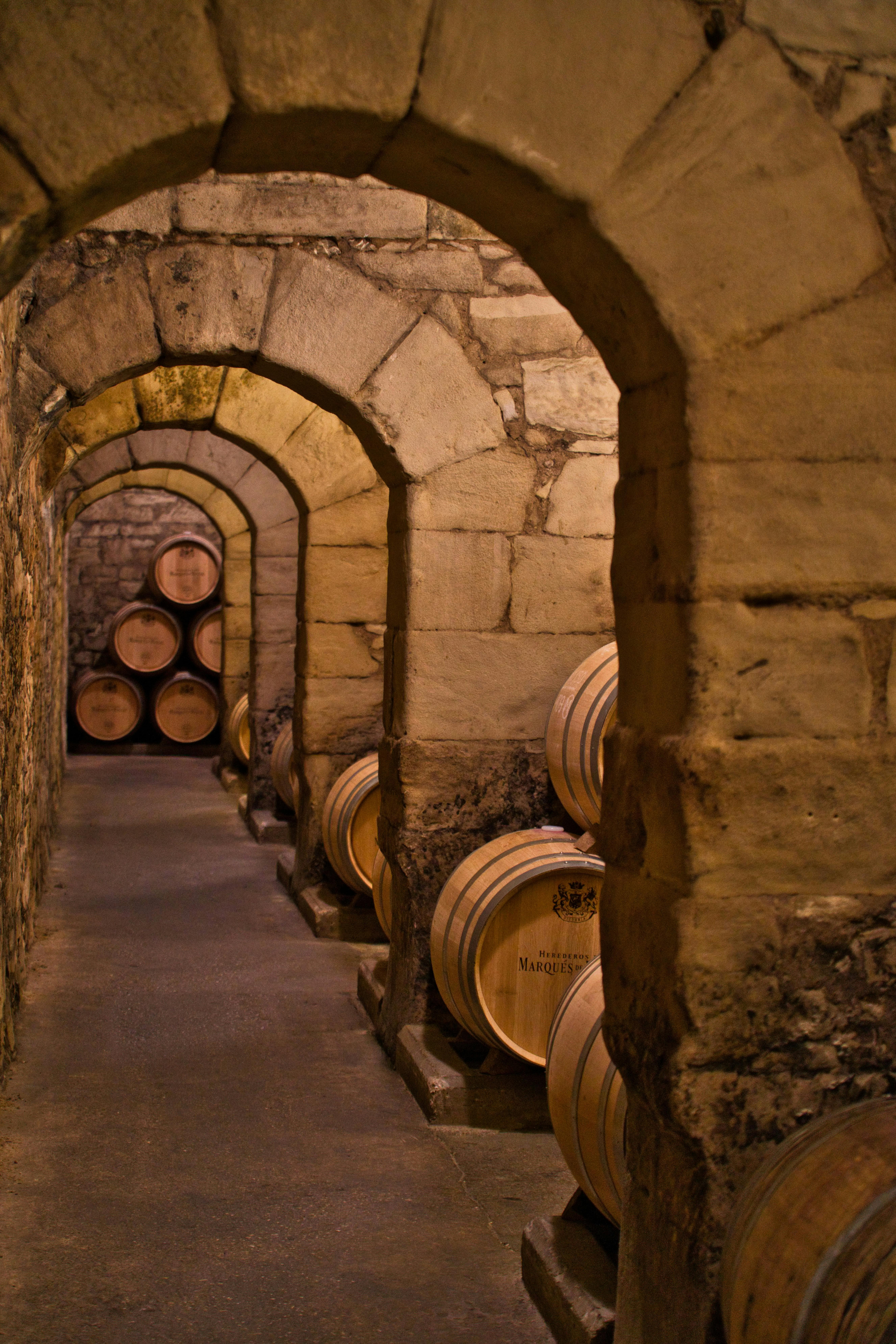 Free Cavernous stone wine cellar in Elciego with wooden barrels. Stock Photo