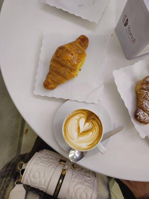 Free Top View of a Coffee and Croissant on the Table  Stock Photo