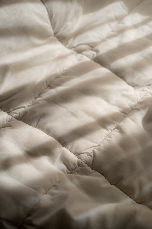 Free Close-up of the Sun Shining on a White Duvet Stock Photo