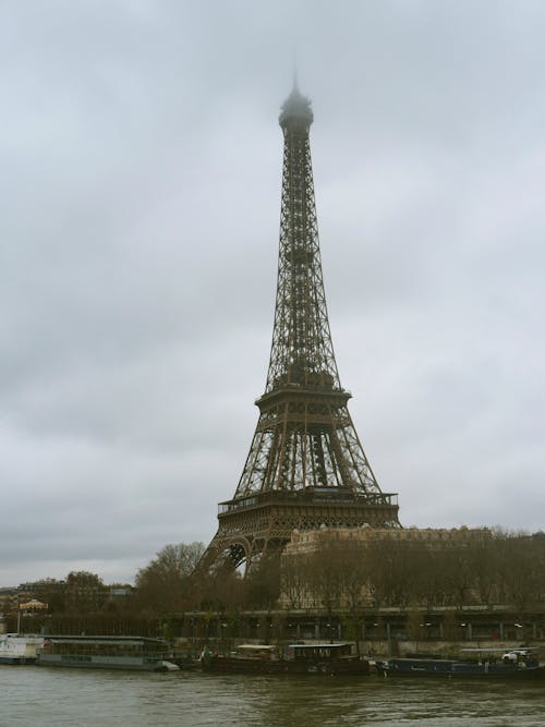 View of the Eiffel Tower from the River Seine on a Cloudy Day
