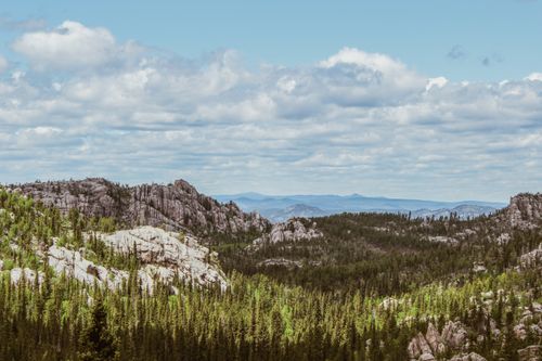 Free A breathtaking view of a rocky mountain landscape under a cloudy sky. Stock Photo