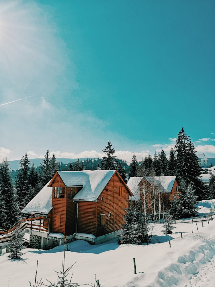 Snow Covered House Under Blue Sky