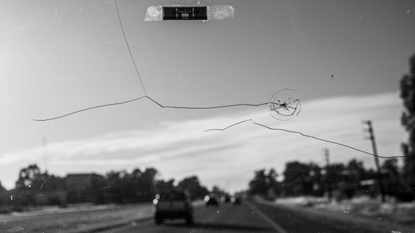 A close view of a cracked car windshield