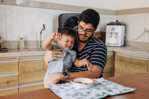 Free Father Sitting with Son in Kitchen Stock Photo