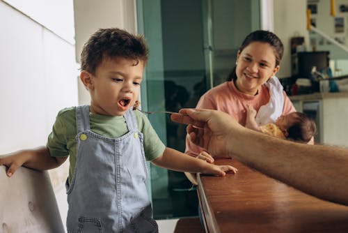 Father Hand Feeding Son