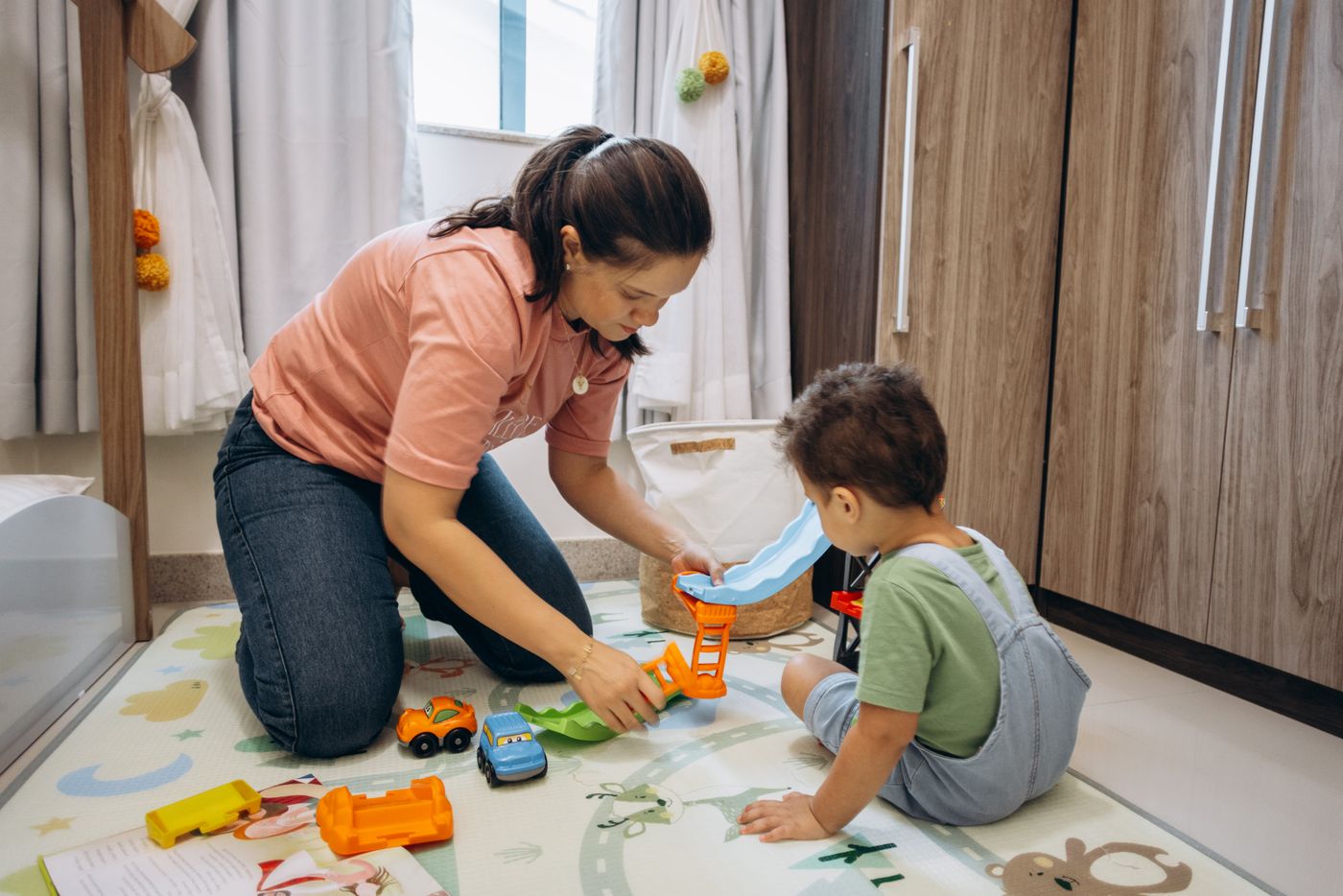 Adult and child playing together with toys