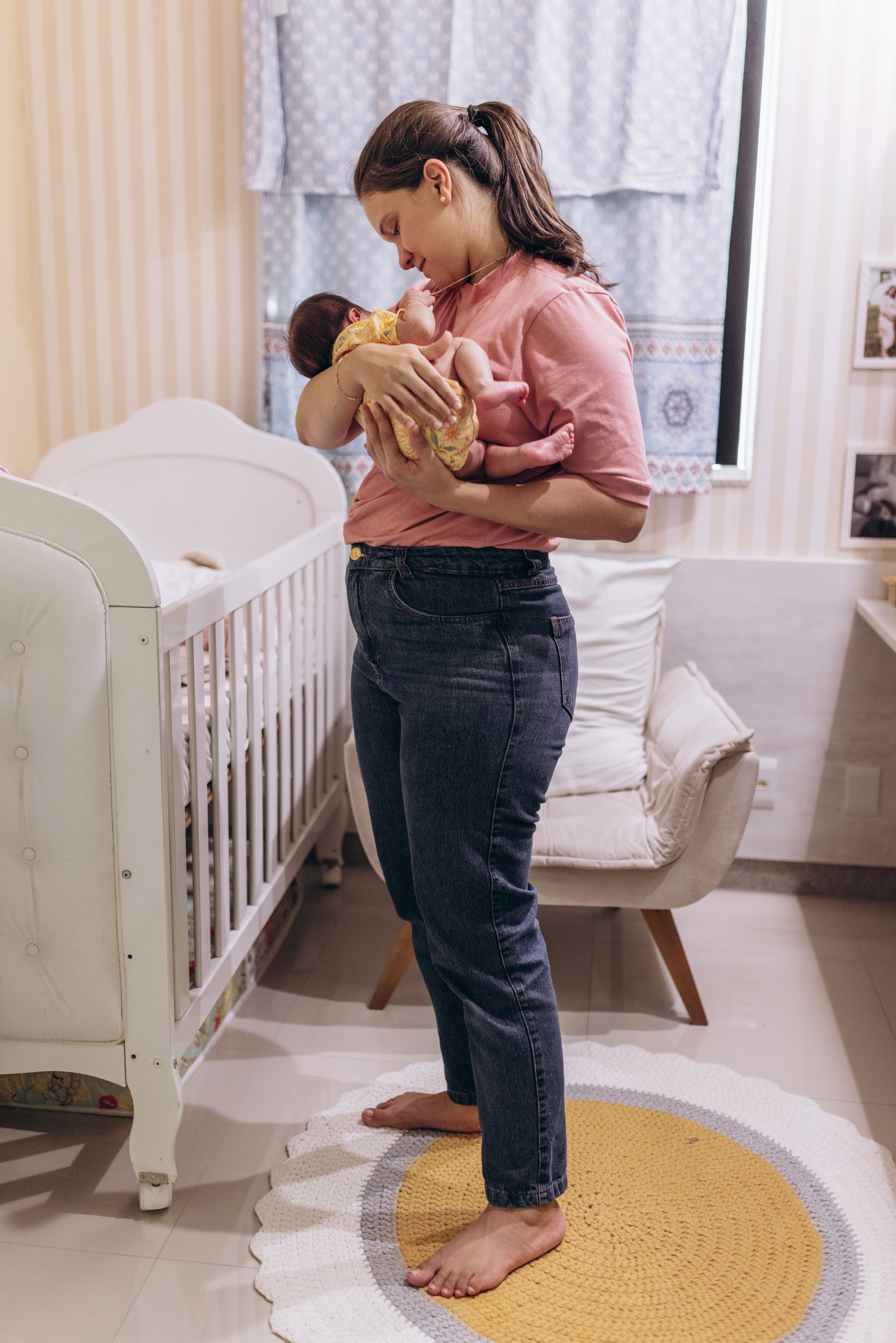 Mother holding her baby in a warm nursery