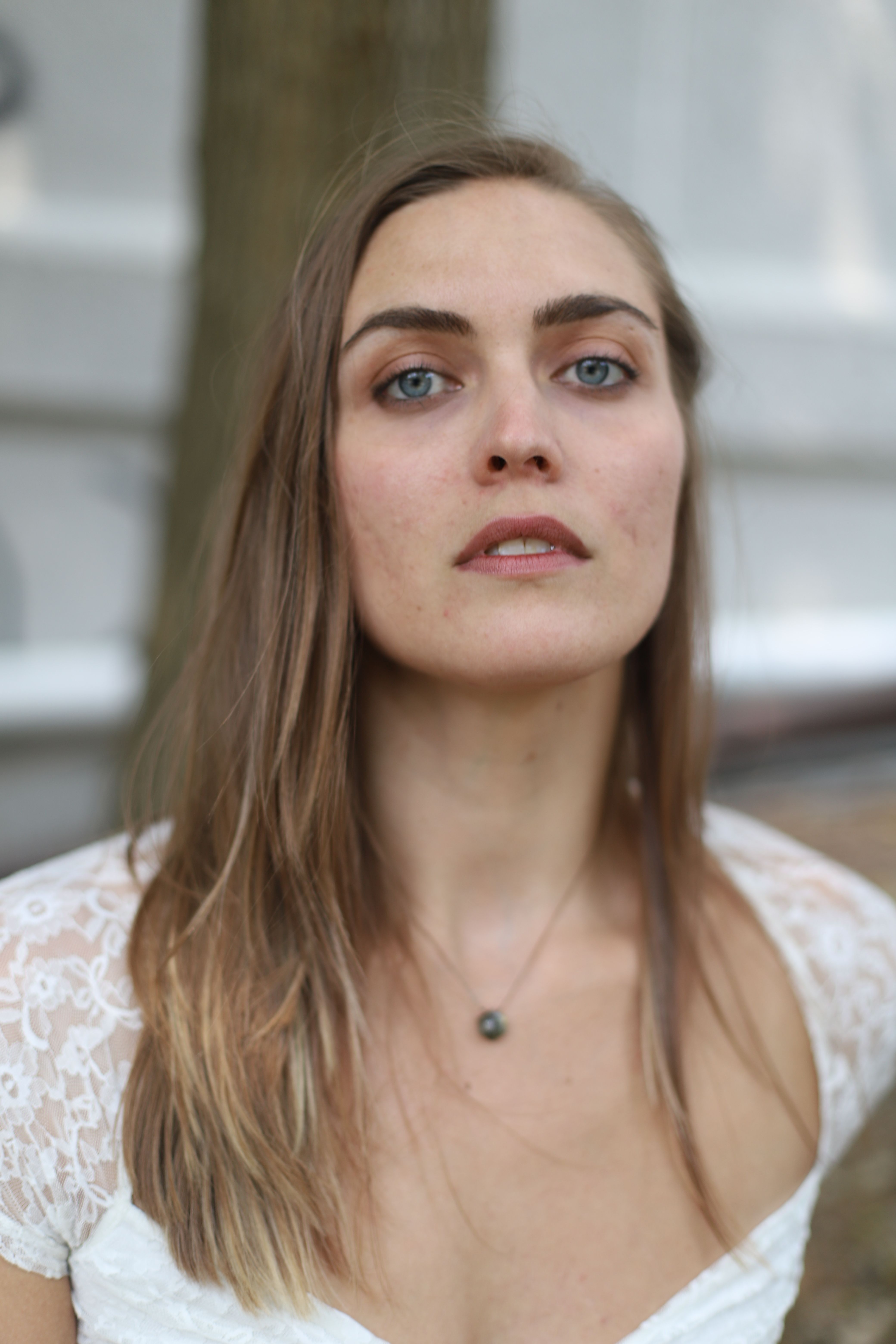 Portrait of a Young Woman in a White Blouse · Free Stock Photo