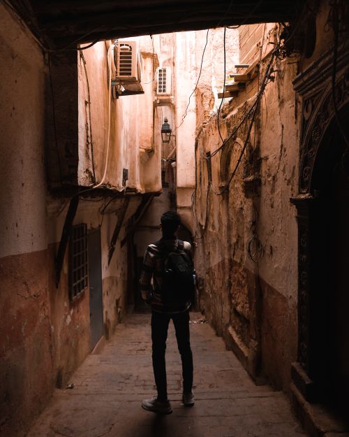 Free A traveler with a backpack walks through the narrow, historic streets of Algiers, Algeria. Stock Photo