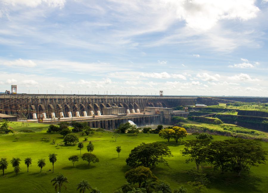Experience the majestic Itaipu Dam surrounded by lush greenery in this scenic landscape view.