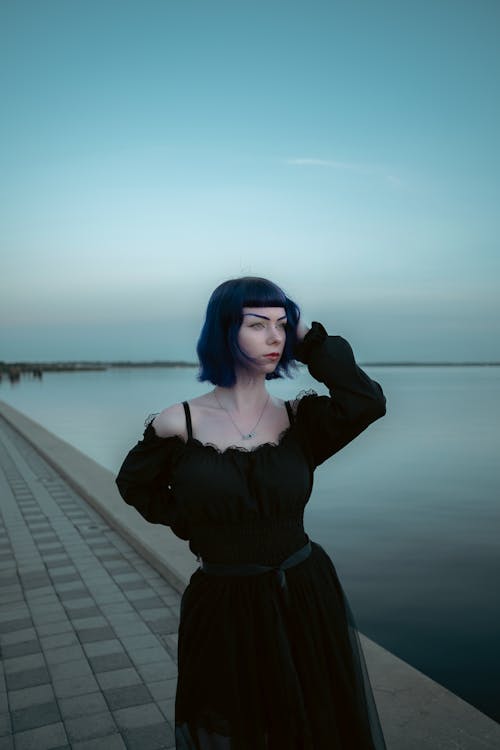 Woman in Black Elegant Dress on Promenade