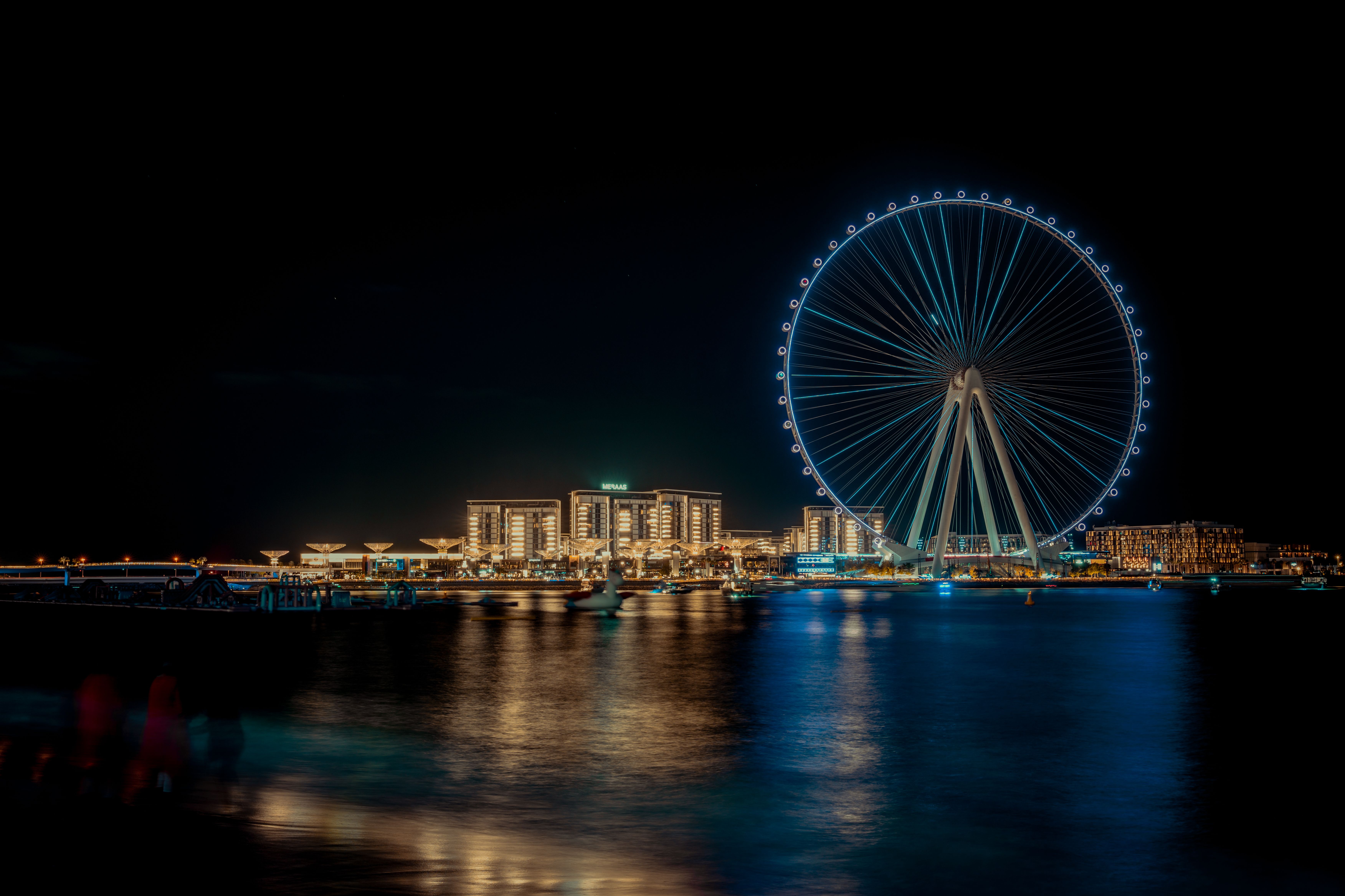 Stunning view of the Ain Dubai Ferris Wheel illuminated at night, overlooking the vibrant cityscape.