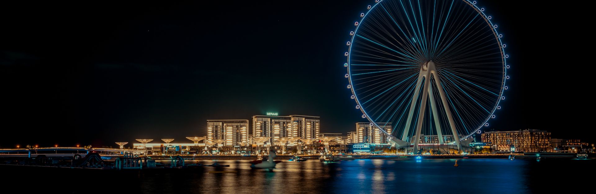 Stunning view of the Ain Dubai Ferris Wheel illuminated at night, overlooking the vibrant cityscape.