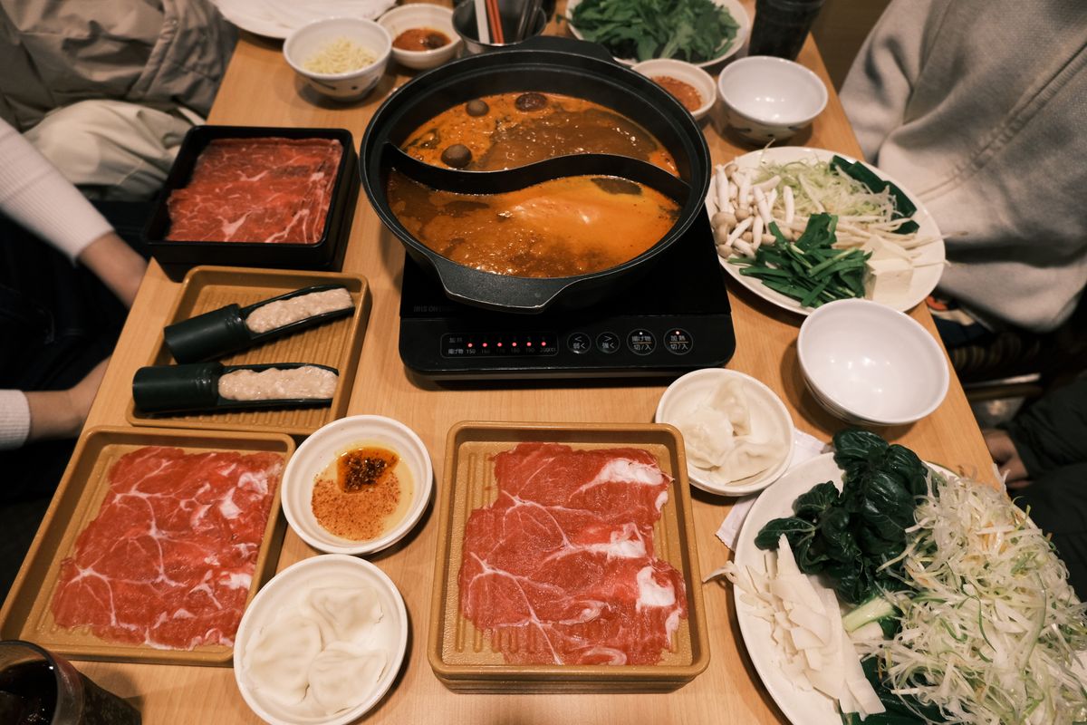 Classic Japanese hot pot meal with fresh beef and vegetables served at the table in Toyohashi, Japan
