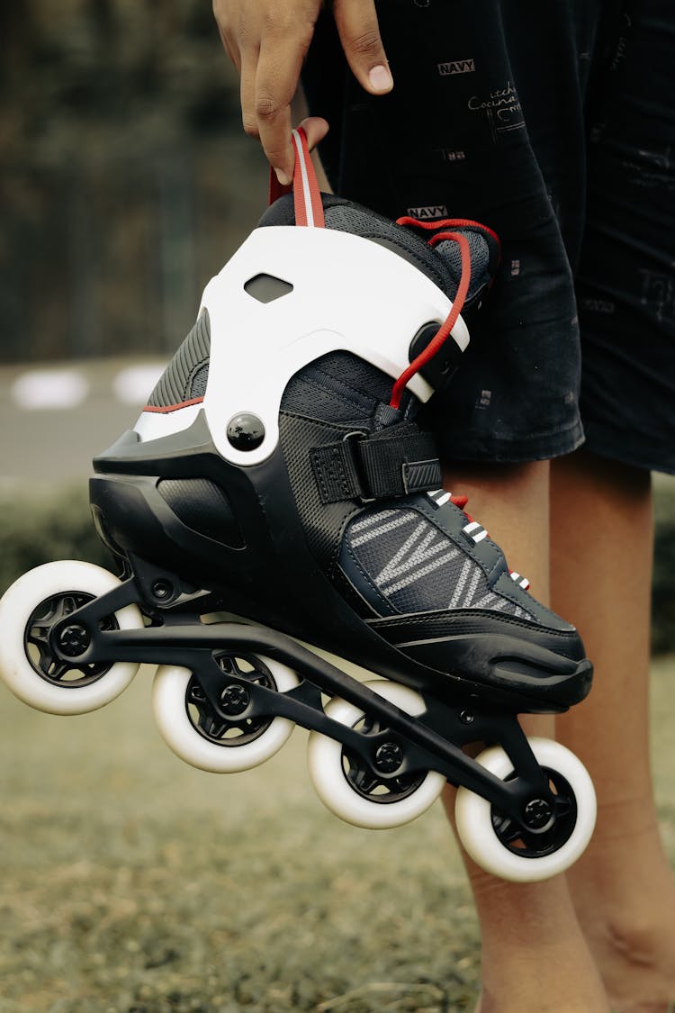 Child Holding A Rollerblade