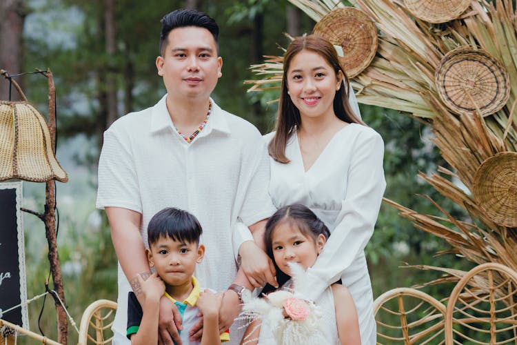 Smiling Parents With Children In White Clothes