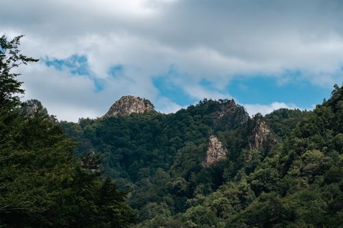 Free Scenic landscape of green mountains under a cloudy sky in Каменномостский, Russia. Stock Photo