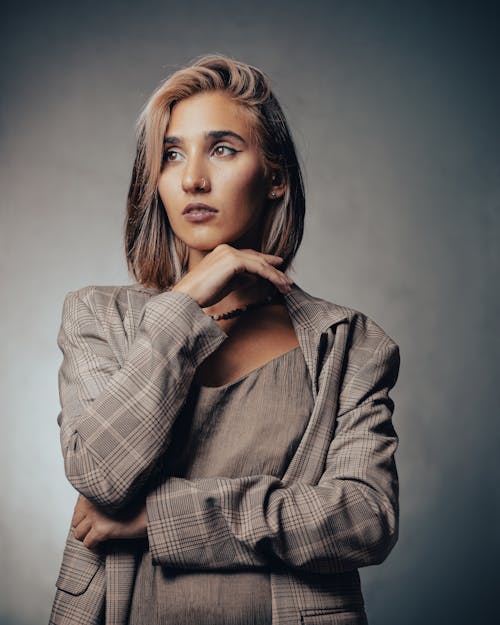 Studio Portrait of a Female Model Wearing a Gray Checked Jacket