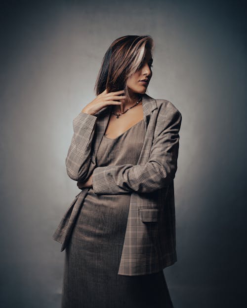 Female Model Wearing a Gray Dress and a Checked Jacket