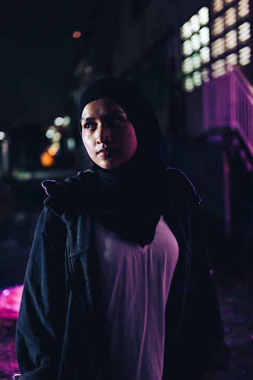 Portrait of a Female Model Wearing a Hijab Standing Outdoors at Night